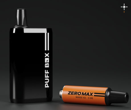 Photo of a black Puff Box device standing upright with a Mango Ice 0mg pod to it's side