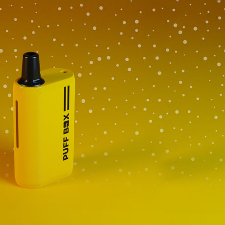Creative image of a yellow Puff Box on yellow background with snow effect